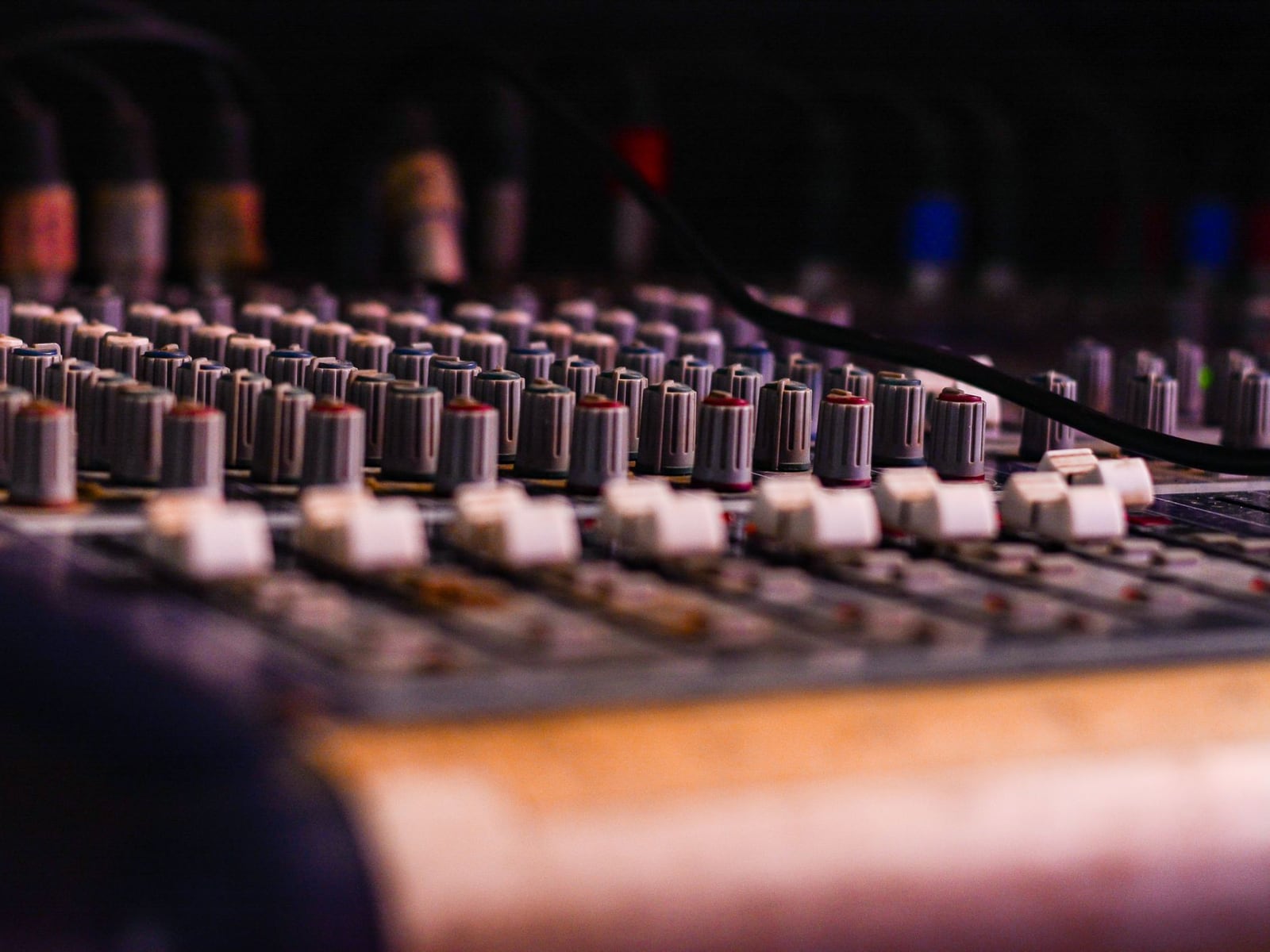 Detailed close-up of a professional mixing console and studio monitors for audio mastering